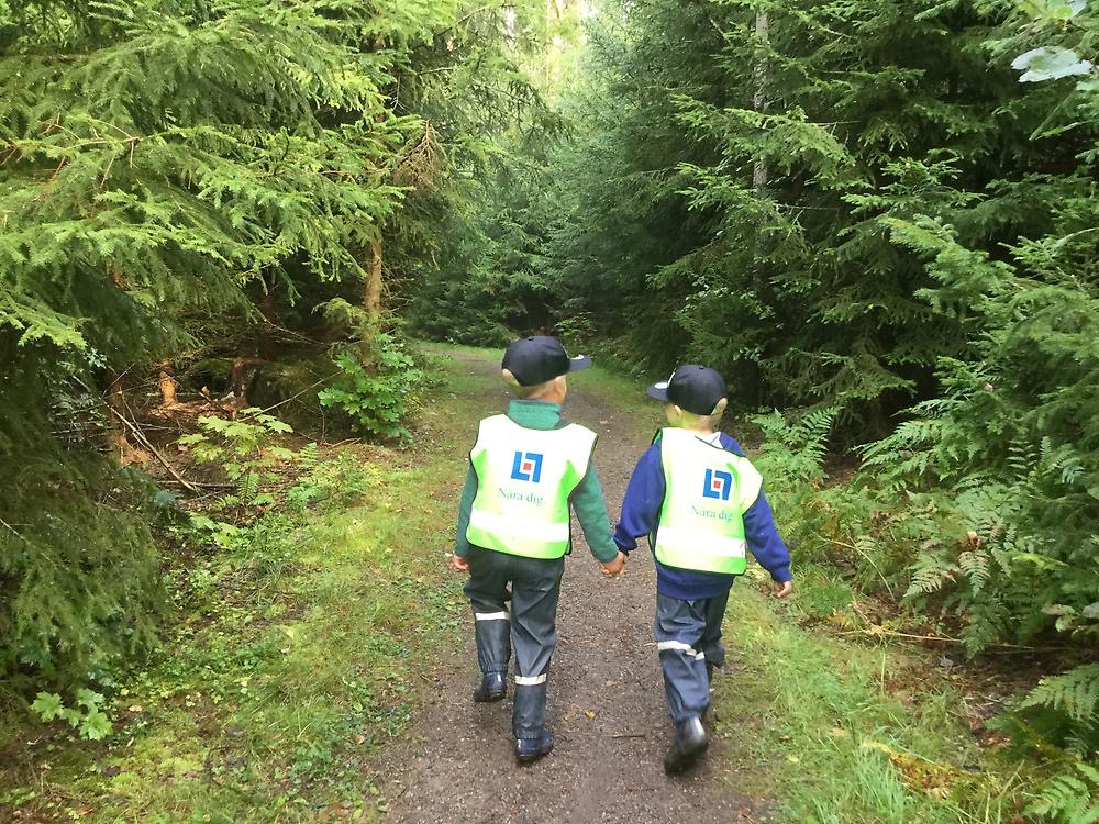 Barn på promenad på skogsstig